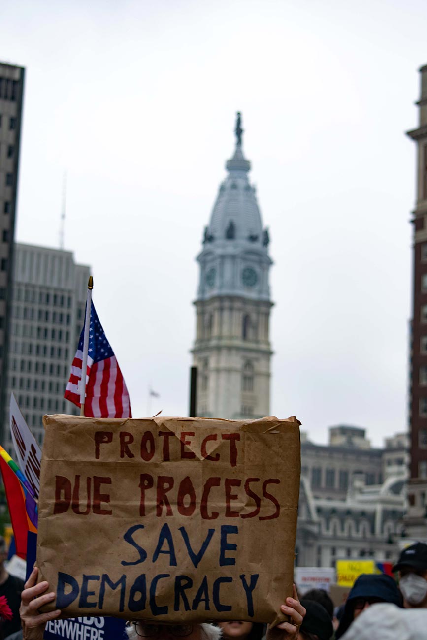Cardboard sign with City Hall in the background at the Philadelphia No Kings Day Protest stating: Protect Due Process, Save Democracy.