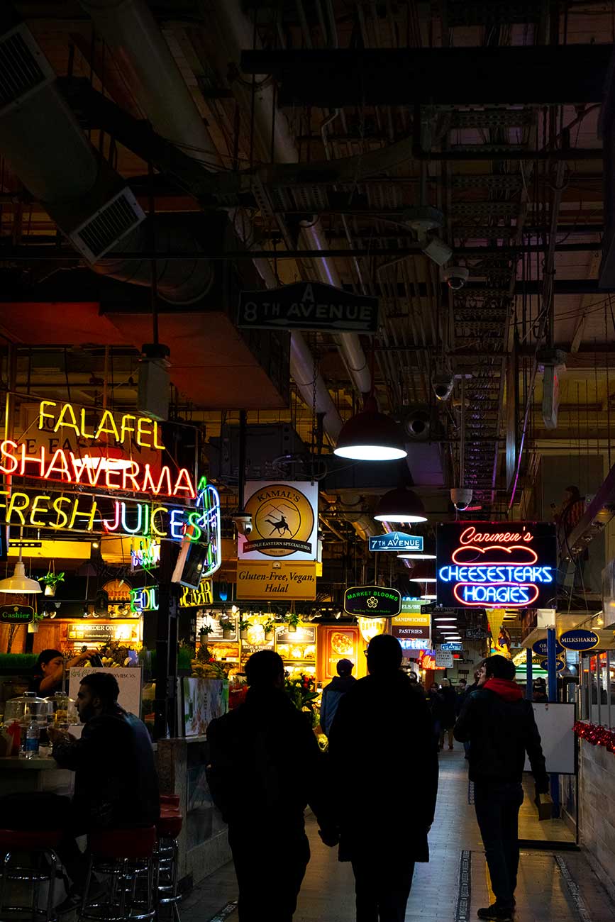 Busy Reading Terminal Market lit up with neon signs, Philadelphia, Pennsylvania