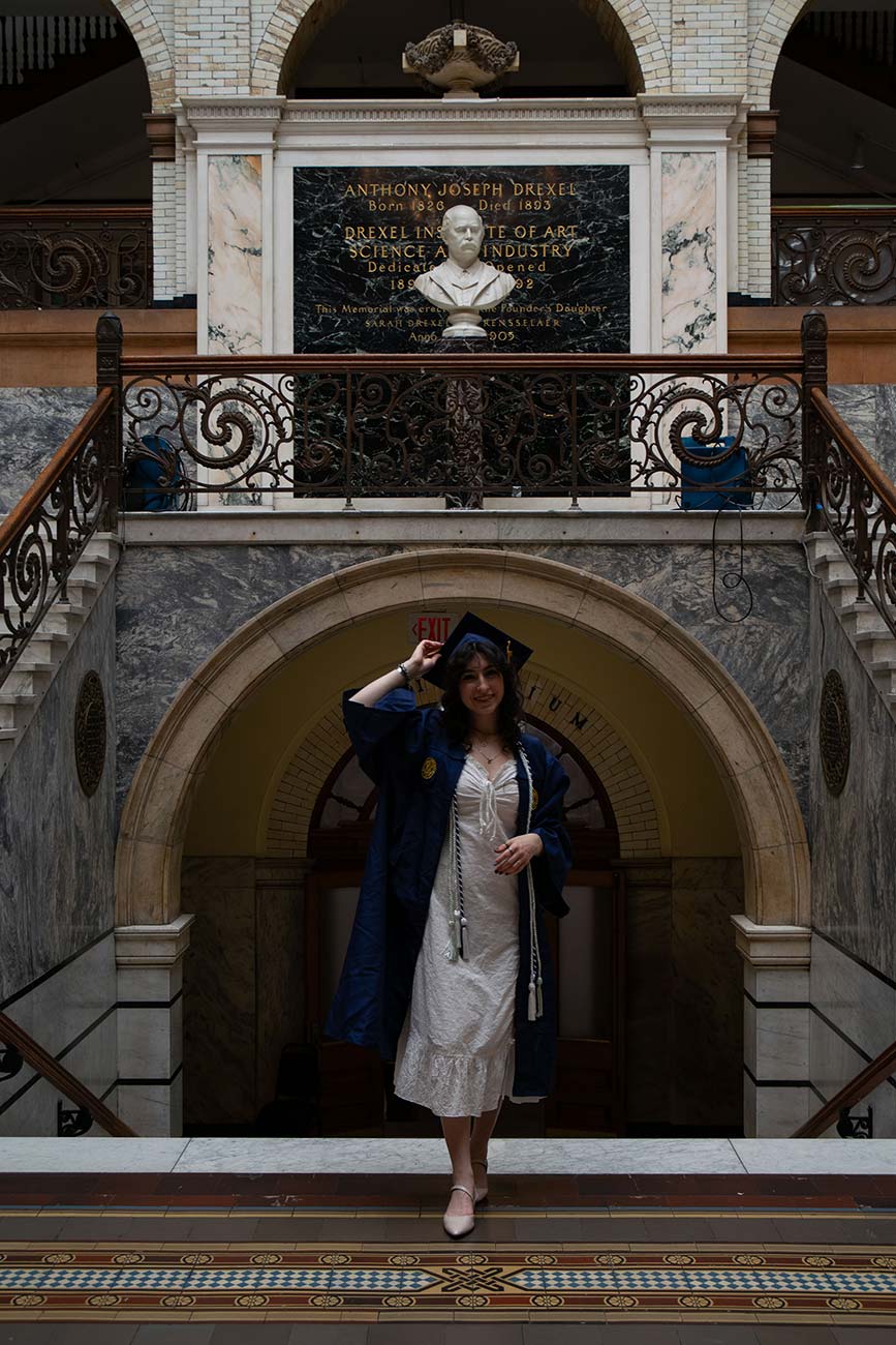 Cameryn in her cap and gown in the Drexel Main Building