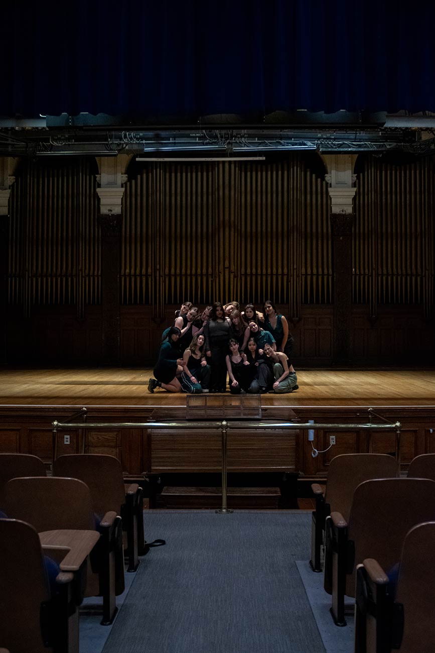 Shot down theater with Drexel University Treblemakers acapella group girls performing together in a group