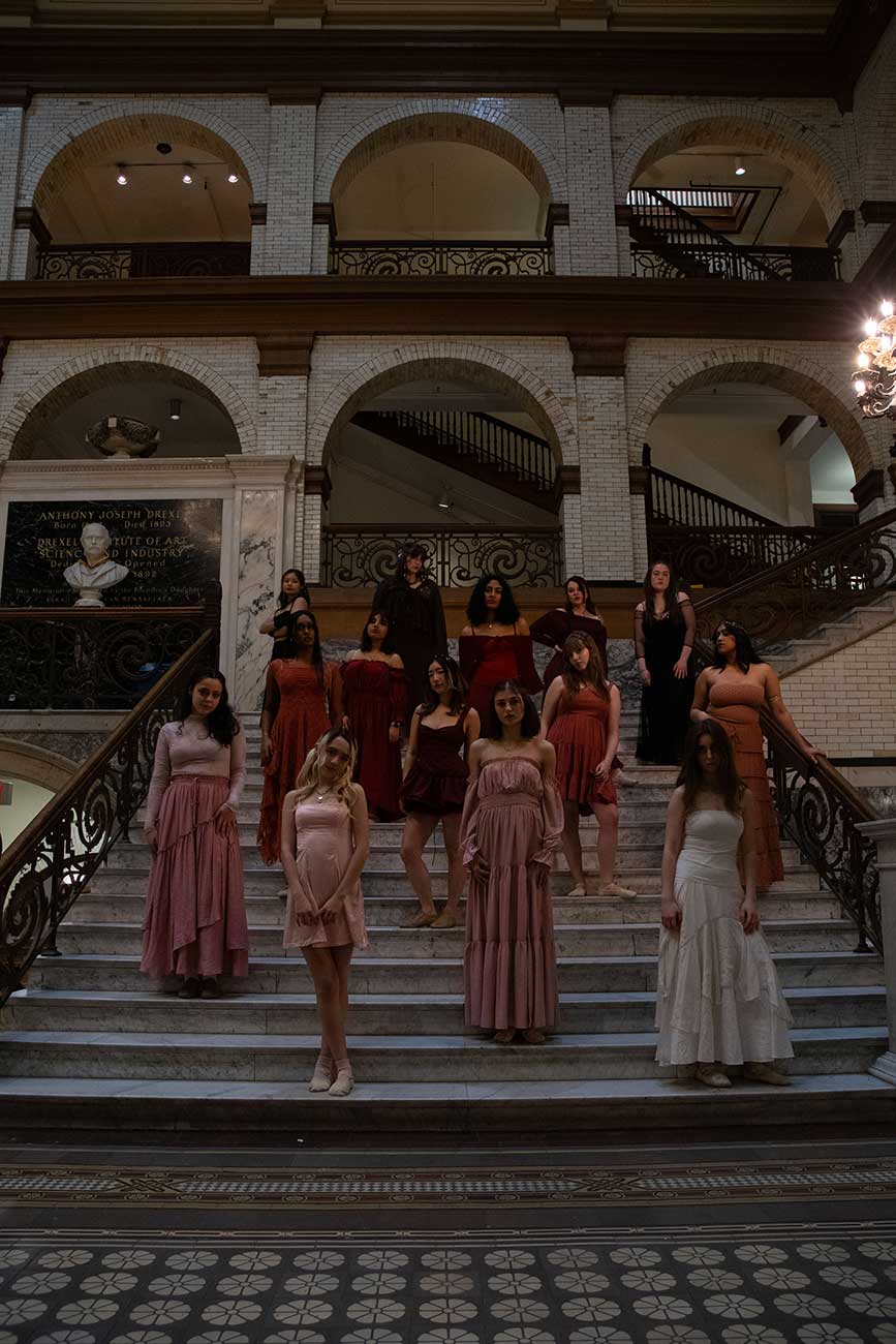 Drexel University Treblemakers acapella group girls standing on marble stairs looking serious