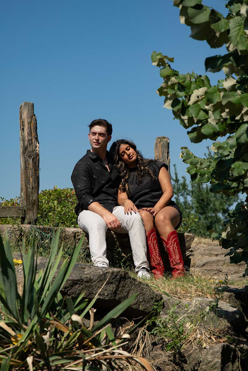 Medha and Will sitting together among plants