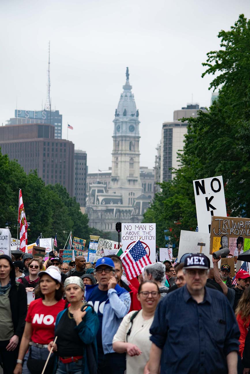 Crowd of protesters in front of Philadelphia City Hall holding signs at the No Kings Day Protest