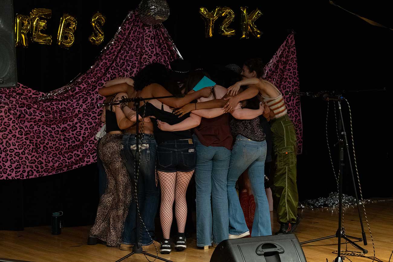 Drexel Treblemakers group hug after their senior concert